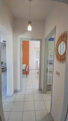 a hallway with a mirror and a room at Lampros house in the countryside in Chania Town