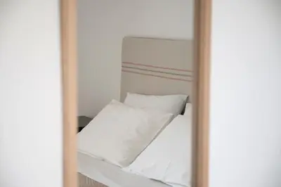 a bed with white sheets and pillows at Elia Apartments in Falasarna