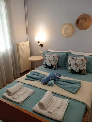 a large bed with towels and pillows on it at ANMI Hospitality in Chania Town