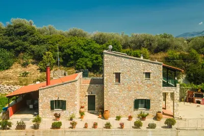a stone building with plants in front of it at Agnadia Villa in Stalos