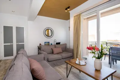 a living room with a couch and a table at G & E Apartment in Kissamos