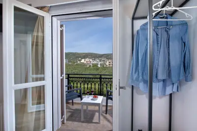 a room with a door open to a balcony at G & E Apartment in Kissamos