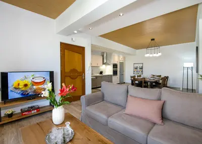 a living room with a couch and a tv at G & E Apartment in Kissamos