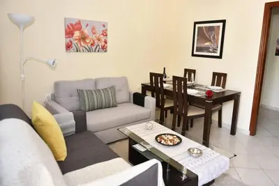 a living room with a couch and a table at Eleni's Σπίτι μπροστά στη θάλασσα in Daratso