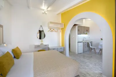 a hotel room with a bed and a kitchen at Aretousa Studio in Chania Town