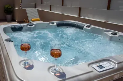 two glasses of wine sitting in a hot tub at Aretousa Studio in Chania Town