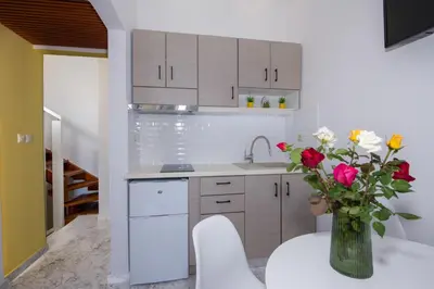 a kitchen with a vase with roses in it at Aretousa Studio in Chania Town