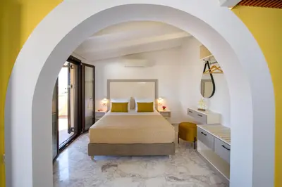 a bedroom with a bed and a large window at Aretousa Studio in Chania Town