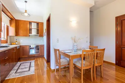 a kitchen with a dining room table and chairs at Gold Crest Home in Drapanias beach, Nopigia in Kissamos