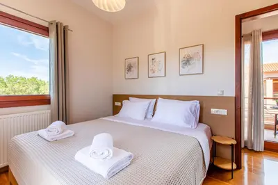 a bedroom with two white towels on a bed at Gold Crest Home in Drapanias beach, Nopigia in Kissamos