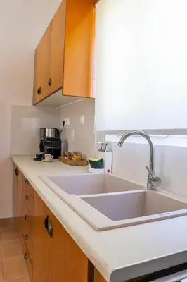 a kitchen with a sink and a counter top at Hygge Home Chania in Chania Town