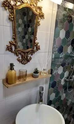 a bathroom with a sink and a mirror on the wall at Hygge Home Chania in Chania Town