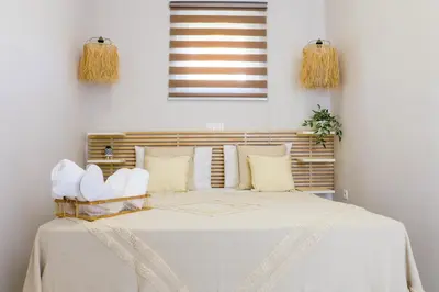 a bedroom with a bed with white sheets and pillows at Hygge Home Chania in Chania Town