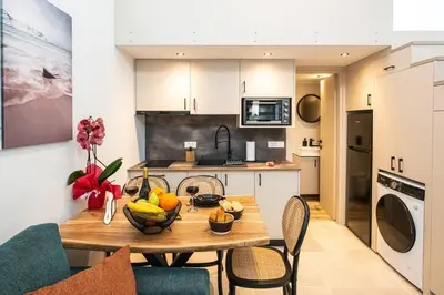 a kitchen with a table with a bowl of fruit on it at Ontas apartment in Kissamos in Kissamos