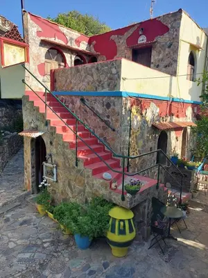 a stone building with a staircase in front of it at Kastania..2 in Kiolianá