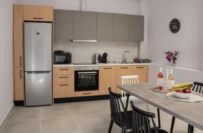 a kitchen with a table and a refrigerator at Vesta suite&studio in Chania Old Town in Chania Town