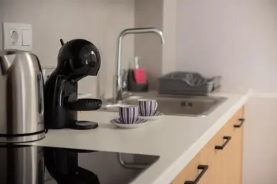 a kitchen counter with a coffee maker and a sink at Vesta suite&studio in Chania Old Town in Chania Town