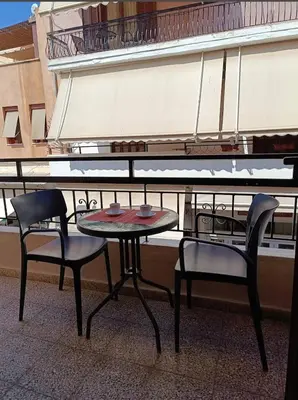 a table and two chairs next to a piano at Vesta suite&studio in Chania Old Town in Chania Town